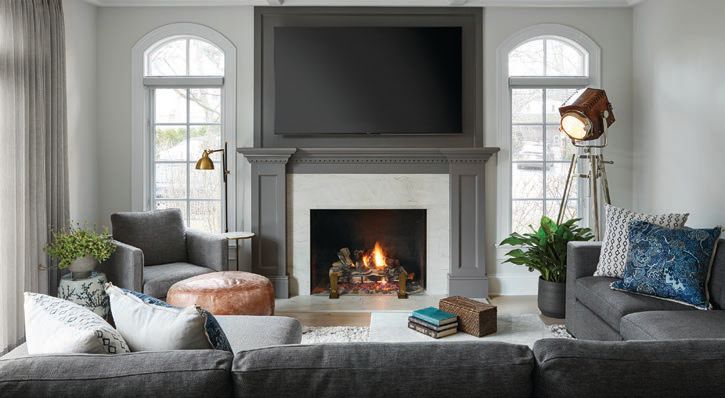 A mantel painted in Benjamin Moore’s Silver Dollar sets a chic gray tone in the family room, which also features a locally made sofa designed by Inspired Interiors PHOTOGRAPHED BY DUSTIN HALLECK