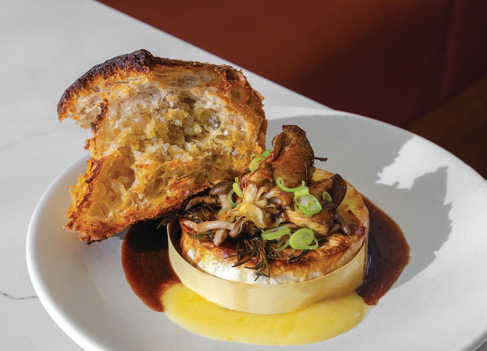 LeTour’s menu tempts with a full-wheel baked Camembert
with roasted wild mushrooms and marrow butter jus PHOTO BY KIM KOVACIK