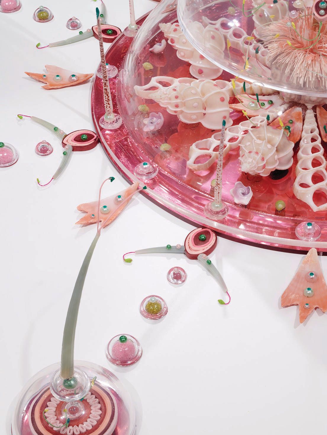 “Elegies of Proxima b” (2019, various cut and polished seashells, sea urchin spines, green tusks, squilla claws, butterfly wings, cut paper, colored powder pigments, colored plastic beads, acrylic domes, brass rod, colored mirrored Plexiglas, glue and acrylic on wood) image courtesy of the artist