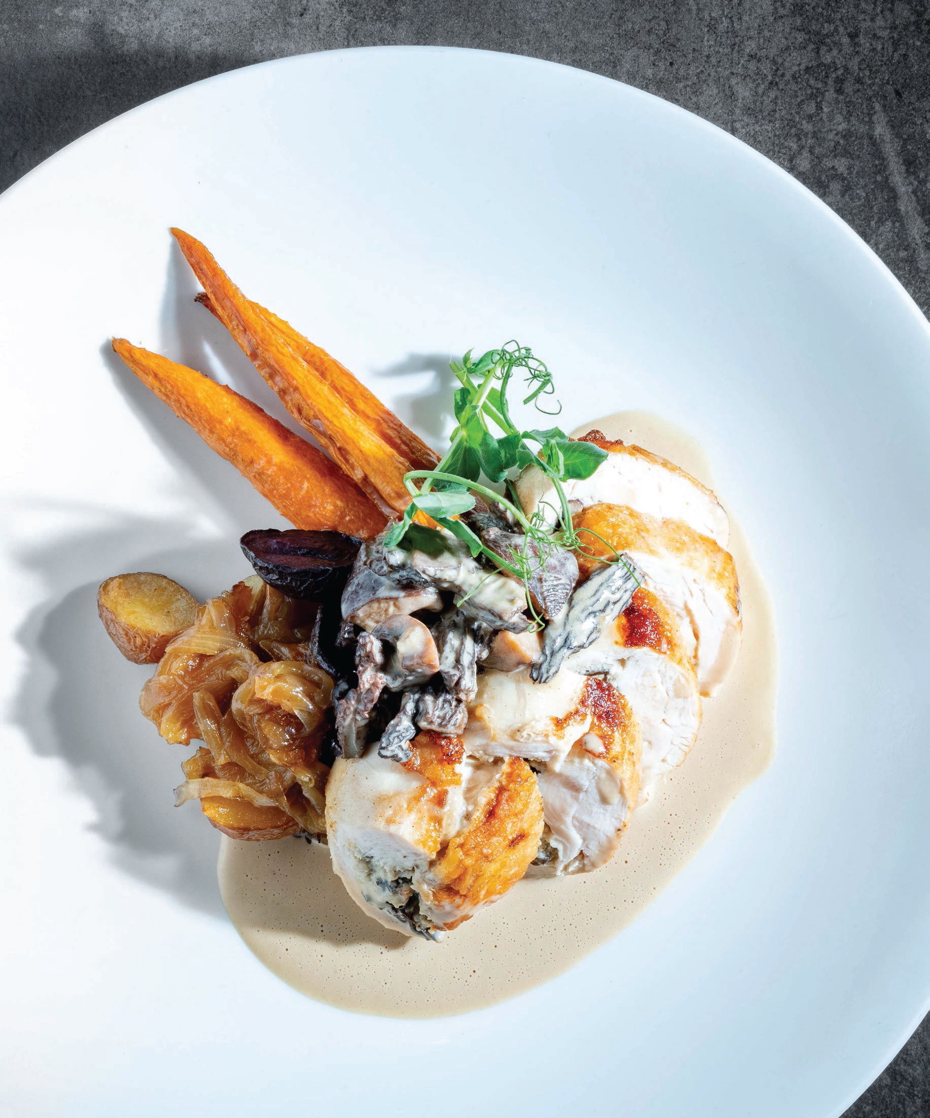 Aboyer’s mushroom-stuffed breast of hen with duck fat potatoes and morel mushroom sauce PHOTO BY THOMAS GAVIN